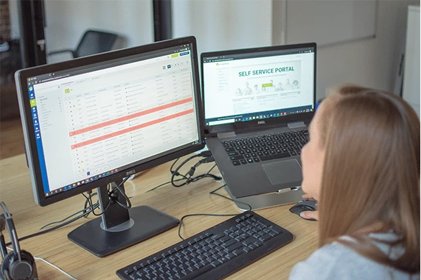 monitor and laptop showing the self service portal login page